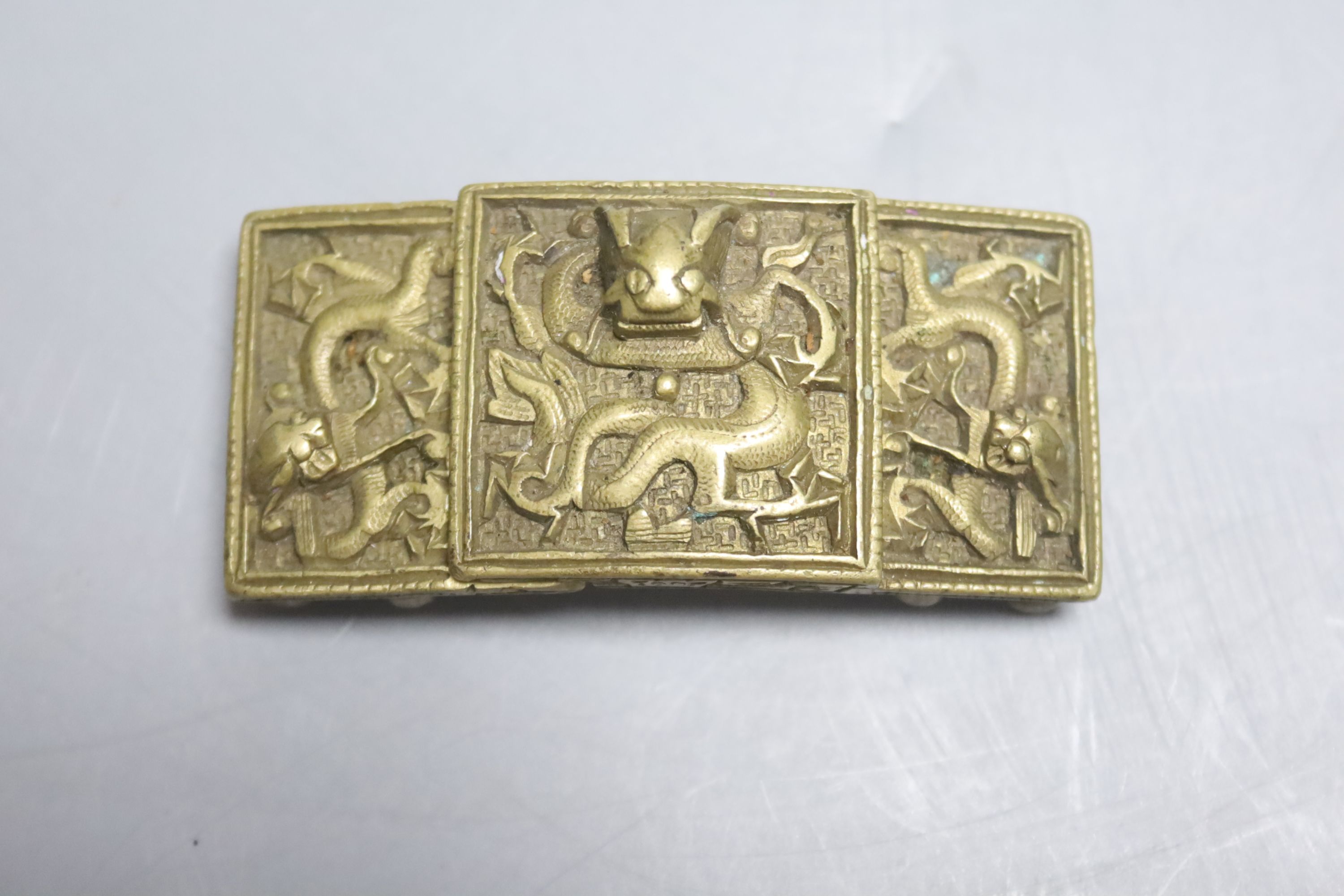 A Chinese or South East Asian bronze two piece dragon belt buckle, 19th century